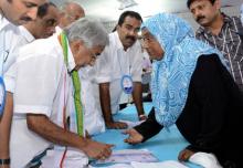 Chief Minister Oommen Chandy sanctioning assistance from distress relief fund (file photo)
