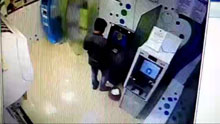 An Indian suspect withdrawing money from ATM